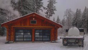 sugar shack with collection truck in snowy driveway
